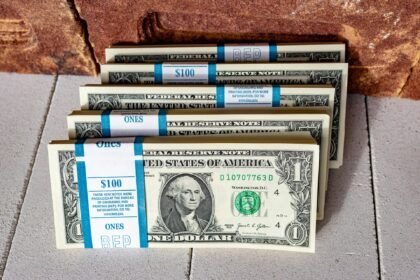 Self directed ira real estate concept shown with stacks of US dollar bills, symbolizing retirement planning and investment.